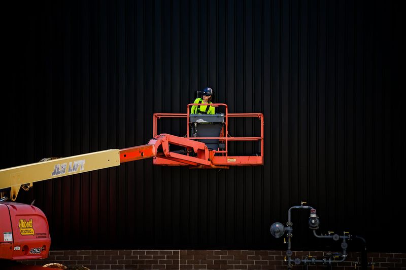 A worker looks out over the job site where the new Timken Elementary School is under construction. At 96,815 square feet, it will more than triple the footprint of the former Mason school where it sits.
