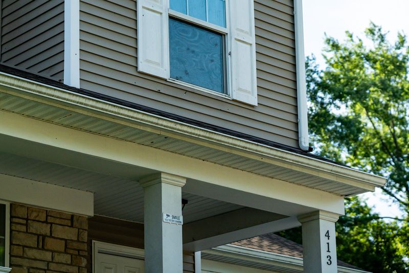 A home on Weeks Street in Akron has evidence of bullet holes in the second-story window.