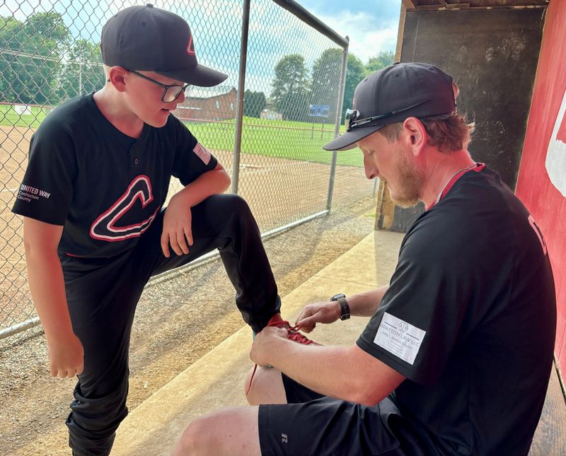 Nick Beckett ties his son Dawson's cleats prior to a Coshocton Recreation League game at Kids America. It's Nick's first year as a coach and his advice to a new coach or dad is the same, expect the unexpected and enjoy the little moments.