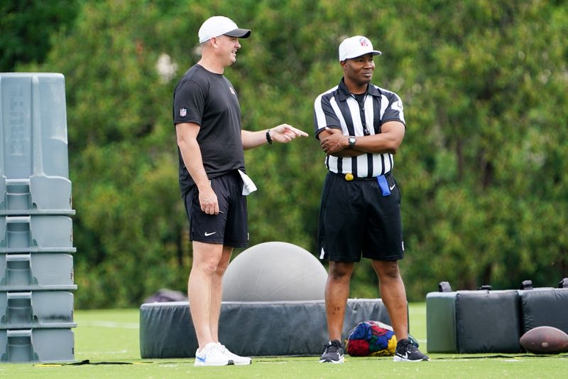 Cincinnati Bengals head coach Zac Taylor speaks with an official during mandatory minicamp on Tuesday, June 16, 2026, at the Kettering Health Practice Fields in downtown Cincinnati.