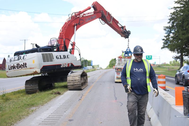 A worker from Clyde contractor Great Lakes Demolition Company works on the bypass roundabout on the east side of Fremont.
