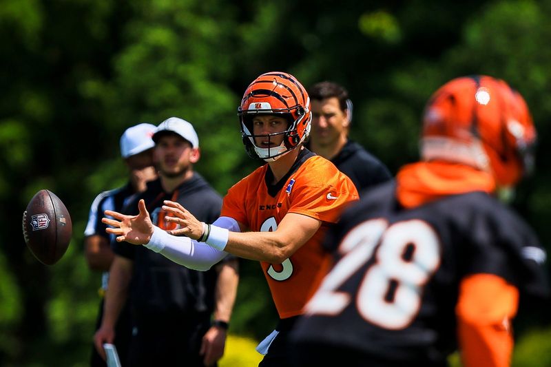 Jun 16, 2026; Cincinnati, OH, USA; Cincinnati Bengals quarterback Joe Burrow (9) snaps the ball during minicamp at Kettering Health Practice Fields. Mandatory Credit: Katie Stratman-Imagn Images