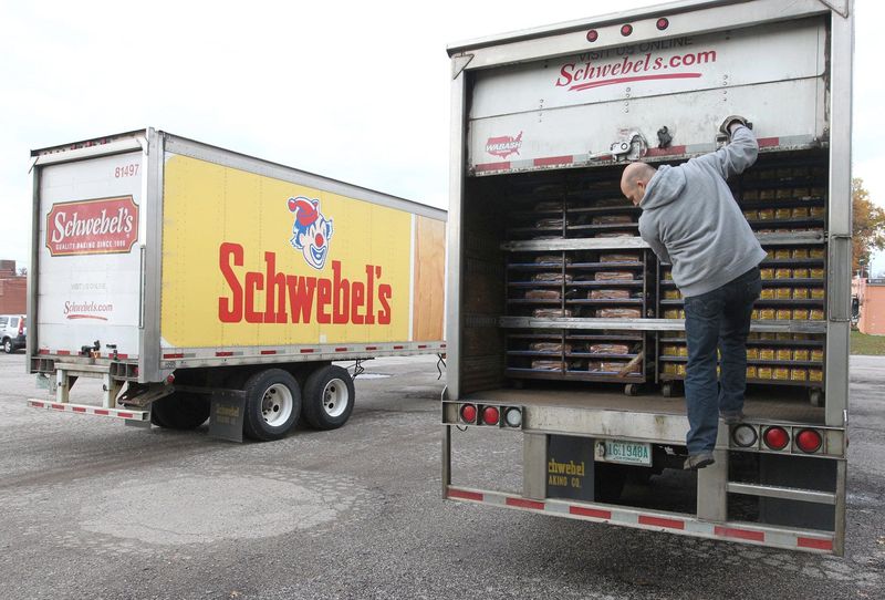 Schwebel's transport driver Brian Achmoody secures his load of bread before heading out on a delivery on Thursday, Nov. 7, 2013, in Cuyahoga Falls, Ohio. Schwebel's announced it is moving its Newberry Street bread production to a updated line in Solon. (Phil Masturzo/Akron Beacon Journal)