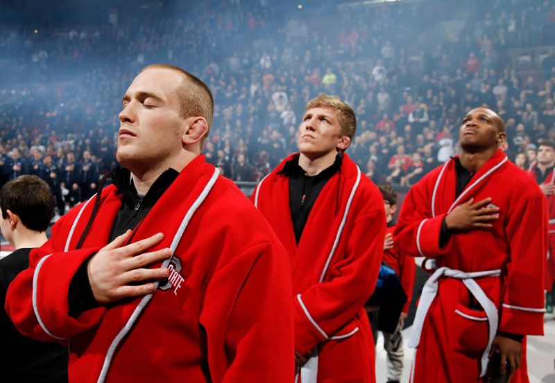 Ohio State Buckeyes wrestler Kyle Snyder, left, stands during the national anthem, before a NCAA wrestling dual match between the Ohio State Buckeyes and the Penn State Nittany Lions on Friday, February 3, 2017 at Value City Arena in Columbus, Ohio.