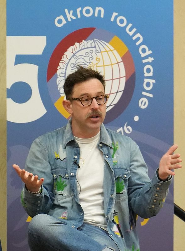 Vinnie Cimino, co-owner and chef at Cordelia and ROSY in Cleveland, gestures as he addresses the Akron Roundtable audience at Quaker Station in Akron June 23, 2026.
