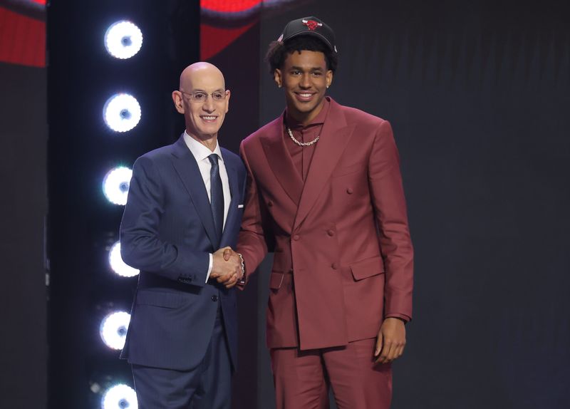 NBA commissioner Adam Silver greets the 15th pick in the 2026 NBA draft, Texas guard Dailyn Swain, after he was selected by the Chicago Bulls at Barclays Center.