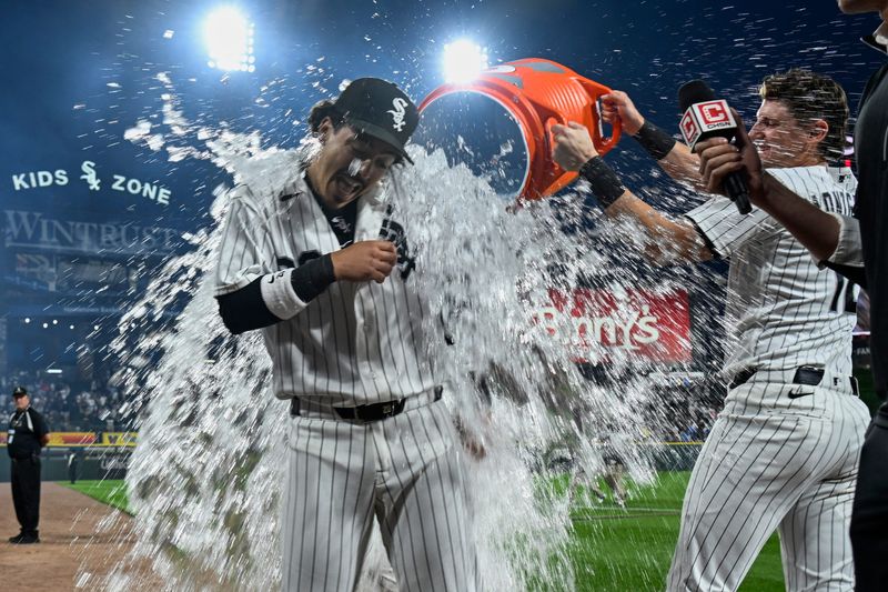 Jun 23, 2026; Chicago, Illinois, USA; Chicago White Sox third baseman Miguel Vargas (20) gets doused by second baseman Chase Meidroth (10) after the game against the Cleveland Guardians.
