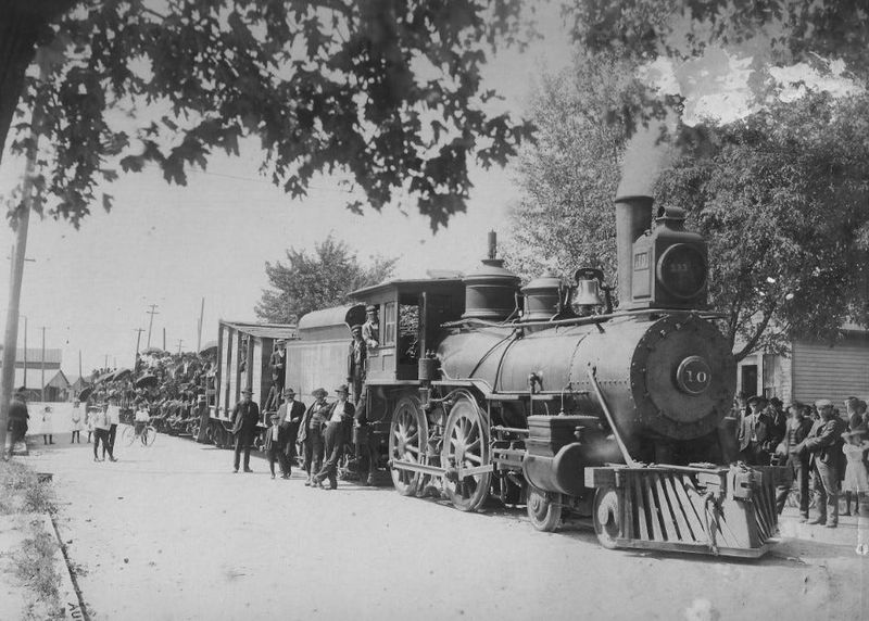 Pictured is the No. 10 steam engine running on the T.P.C. and L. interurban line down the center of Water Street in Oak Harbor pulling flatcars filled with baseball fans.