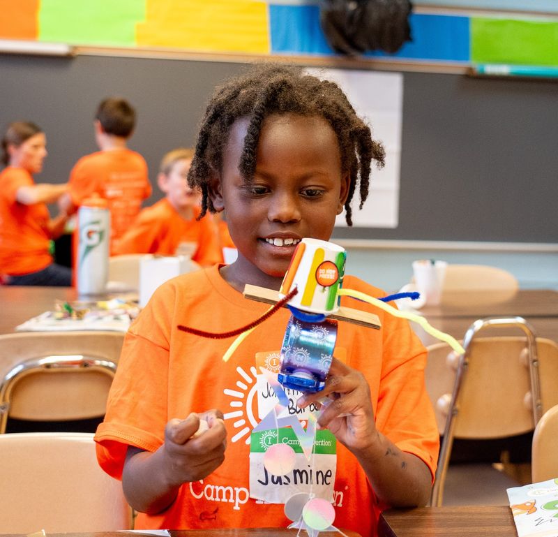 Jasmine Barbera, 5, works on a robot that makes pizza at Camp Invention, a program for children at St. Joseph School in Randolph.