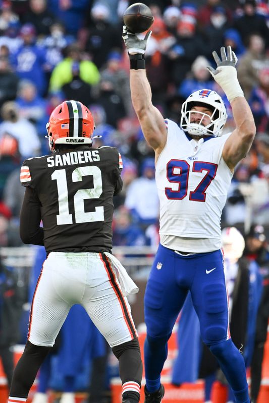 Dec 21, 2025; Cleveland, Ohio, USA;  Buffalo Bills defensive end Joey Bosa (97) tips the pass by Cleveland Browns quarterback Shedeur Sanders (12) which then was later intercepted on the play during the second half at Huntington Bank Field. Mandatory Credit: Ken Blaze-Imagn Images