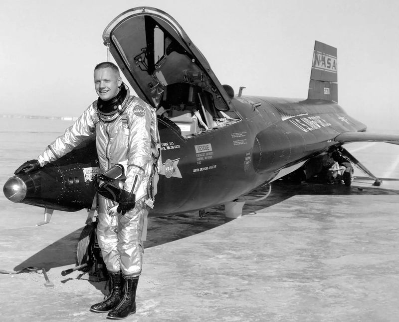 Neil Armstrong stands in front of an X-15 rocket-powered aircraft after a research flight.