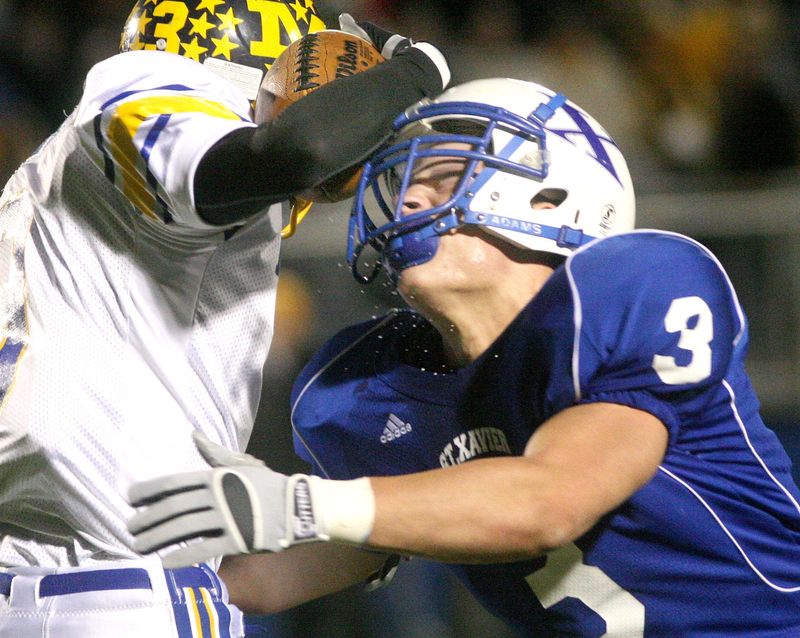 St Xavier's Luke Kuechly (3), forcing a fumble against rival Moeller, also forced a fumble in X's 2007 state championship game win.