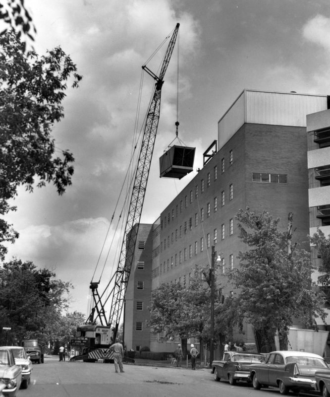 A crane lifts a massive air conditioning unit to the roof of Good Samaritan Hospital on May 18, 1965.