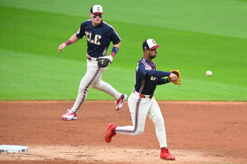 Jun 26, 2026; Cleveland, Ohio, USA; Cleveland Guardians shortstop Brayan Rocchio (4) turns a double play in front of second baseman Travis Bazzana (37) in the second inning against the Seattle Mariners at Progressive Field. Mandatory Credit: David Richard-Imagn Images