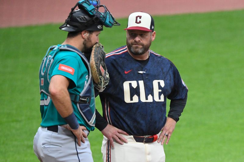 Jun 26, 2026; Cleveland, Ohio, USA; Seattle Mariners catcher Cal Raleigh (29) talks with Cleveland Guardians manager Stephen Vogt (12) in the second inning at Progressive Field. Mandatory Credit: David Richard-Imagn Images