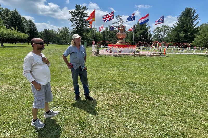 Kamal Dhimal, left, president and CEO of the Global Bhutanese Hindu Organization, shows David Swalley a few updates at the organization's world headquarters in Galion.