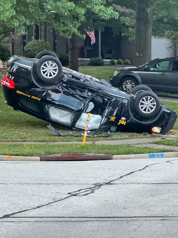 A crashed park ranger cruiser overturned in a yard at the corner of Saybrooke Boulevard and Bunker Lane in Stow on July 7, 2026.
