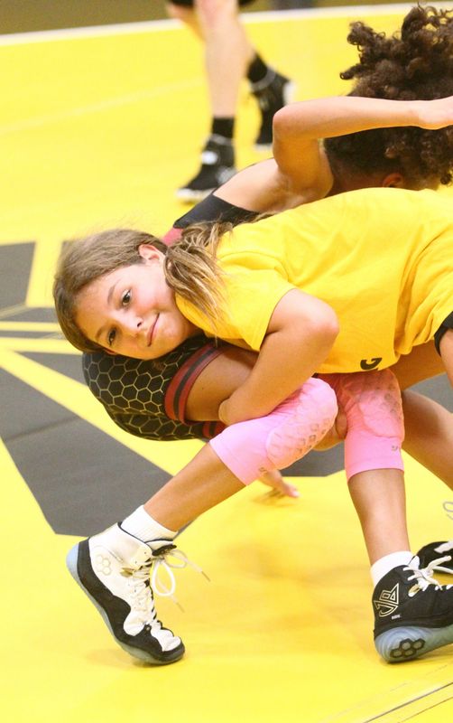 Watkins fifth-grader Kolby Riggs drills with Licking Heights fifth-grader Brystal Barnett-Jeffries during a girls open mats at Watkins Middle School on July 8, 2026.
