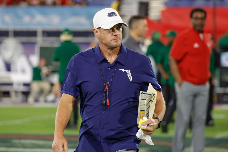 Nov 1, 2024; Boca Raton, Florida, USA;  Florida Atlantic Owls head coach Tom Herman walks on the field before the game against the South Florida Bulls at FAU Stadium. Mandatory Credit: Reinhold Matay-Imagn Images