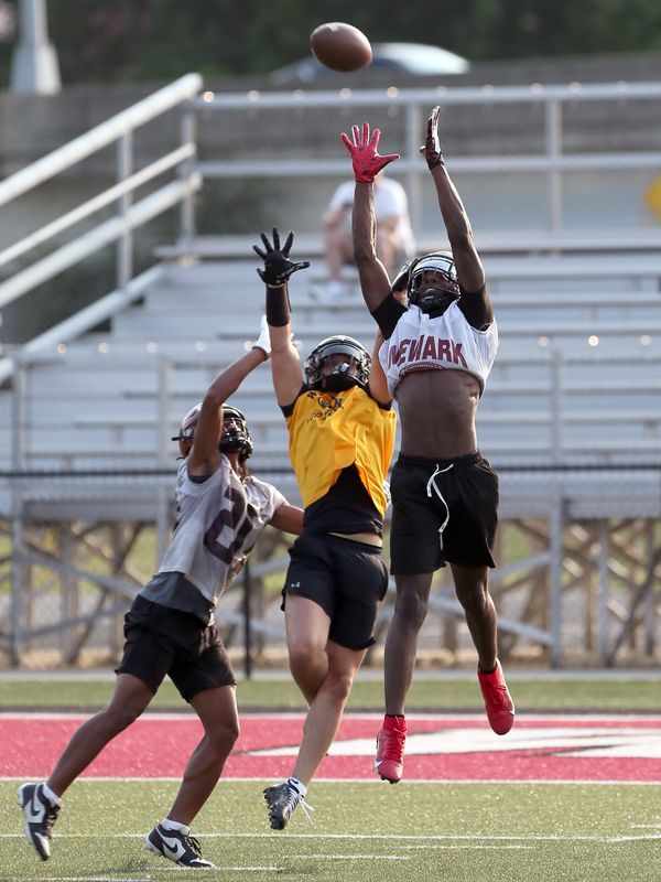 Newark's Noah Jackson intercepts a pass during a 7 on 7 passing scrimmage against Watkins Memorial on Tuesday, July 14, 2026, at White Field.