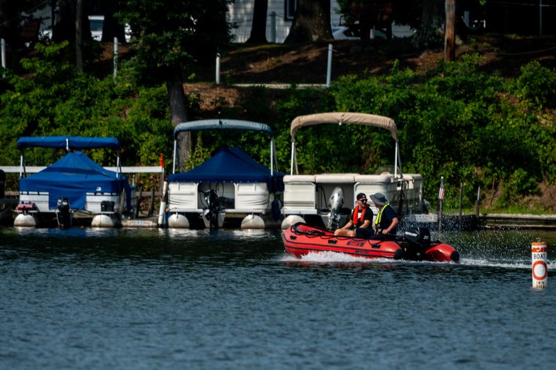 A search and rescue boat unloaded from a Coventry TWP Fire Department trailer begins a search operation for a reported missing boater, July 15, 2026, on the East Reservoir in Akron’s Portage Lakes area.
