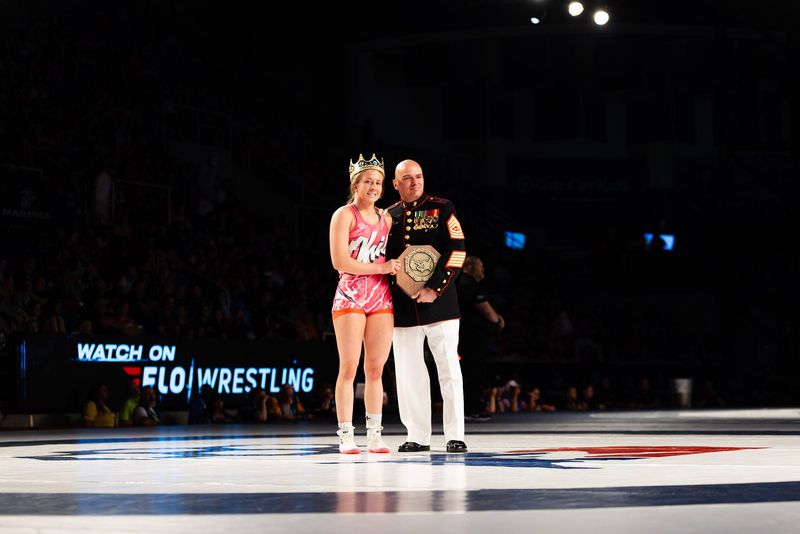 Olentangy Orange's Mackenzie Carder poses with her stop sign after winning Girls Junior Freestyle national championship at 125 pounds in Fargo, ND on July, 18, 2026