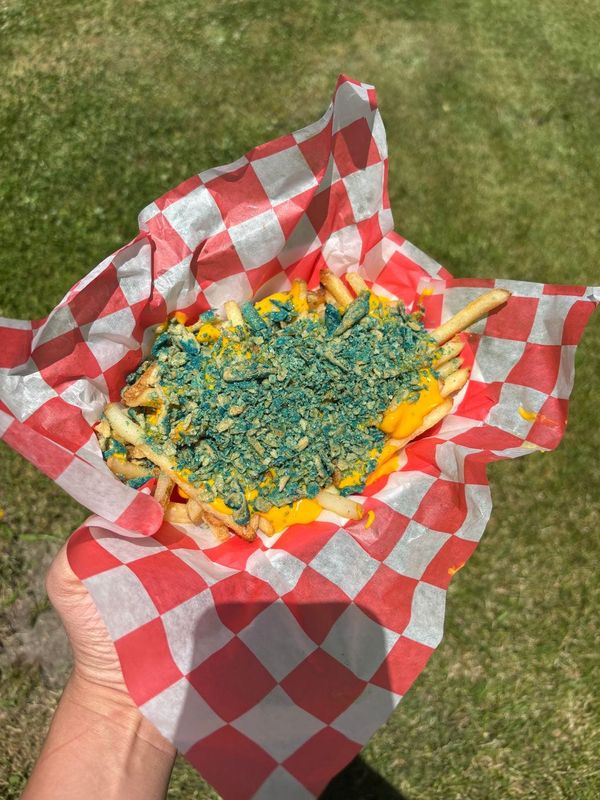 Fresh-cut fries at the 2026 Ohio State Fair are covered in cheddar-cheese sauce and dusted with crushed Blue Heat Takis tortilla chips.