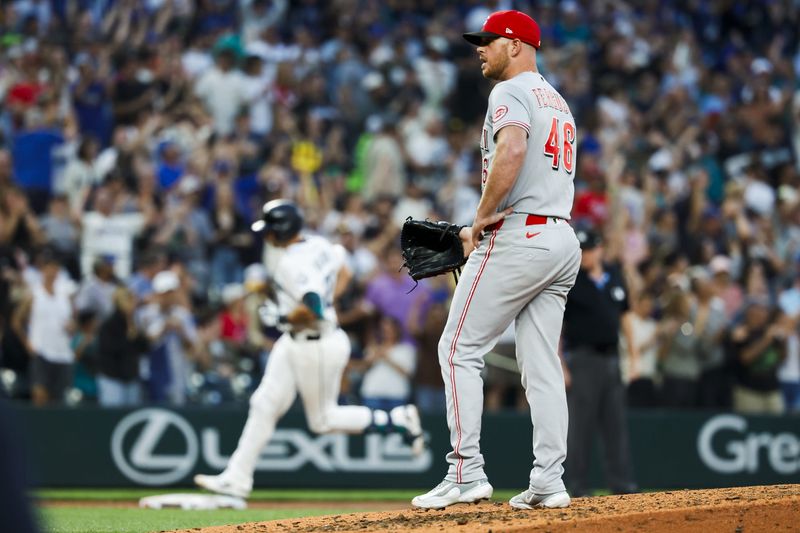 Cincinnati Reds pitcher Caleb Ferguson (46) stands on the mound after surrendering a grand-slam home run to Seattle Mariners catcher Cal Raleigh (29, background) during the seventh inning at T-Mobile Park.