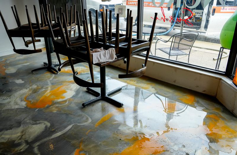 Flood waters broke into the dining area of Neko Sushi & Korean and Japanese restaurant after a heavy rainstorm in the Hyde Park area on Tuesday, July 21, 2026.