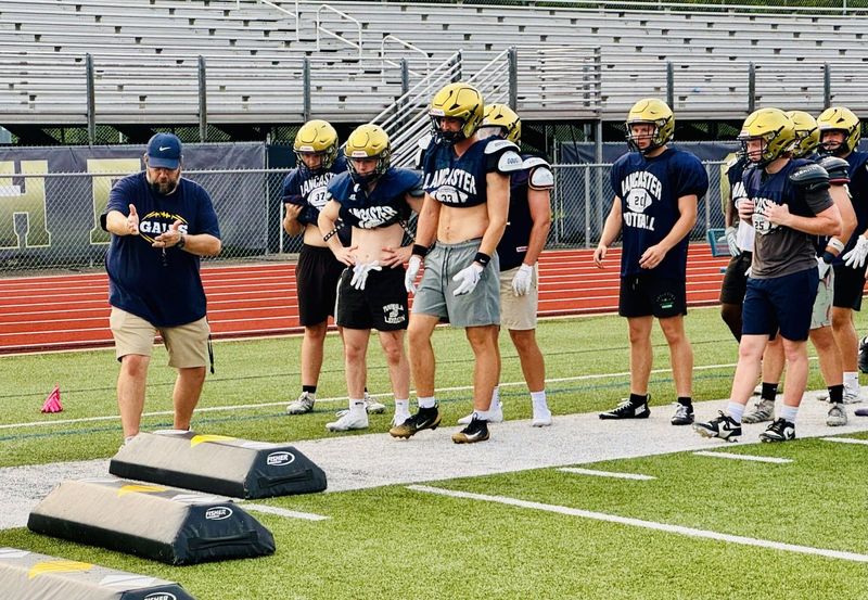 New Lancaster football coach Jeremy McKinney explains a drill to his players during a recent practice on July 20, 2025, at Fulton Field.
