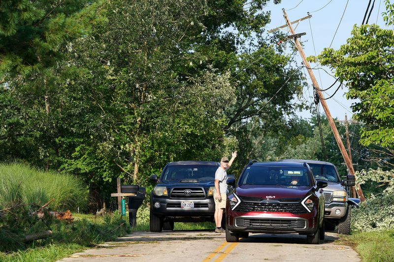 A fallen power line disrupts traffic on Fagins Run Road, Tuesday, July 21, 2026, in Pierce Township. A possible tornado made its way through Clermont County.