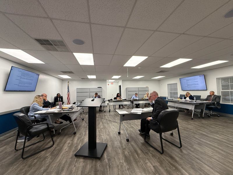 Jerome Township administrator Brandon Standley, middle, is questioned as a witness at a July 21 township hearing on charges against Fire Chief Douglas Stewart.