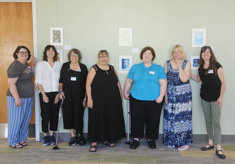 Liz Gibbons-Camp, left, with the Chillicothe and Ross County Public Library and  Artist Jessica Held, right, celebrate with other artists during the opening of the Creative Aging Art gallery at the Northside Library.