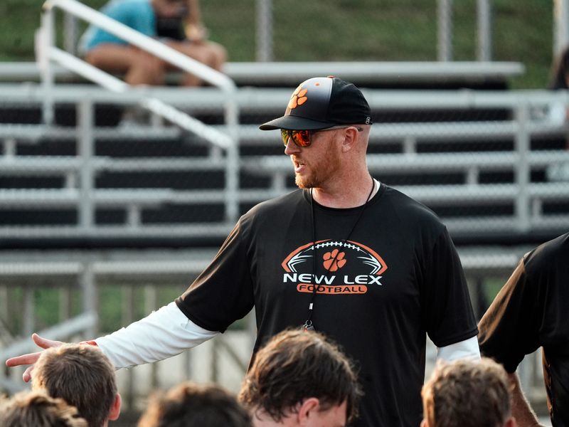 New Lexington head coach Kevin Board talks to his team during a break in the action at the team's 7-on-7 passing scrimmage on Thursday, July 16, at Jim Rockwell Stadium in New Lexinfgton, Ohio.