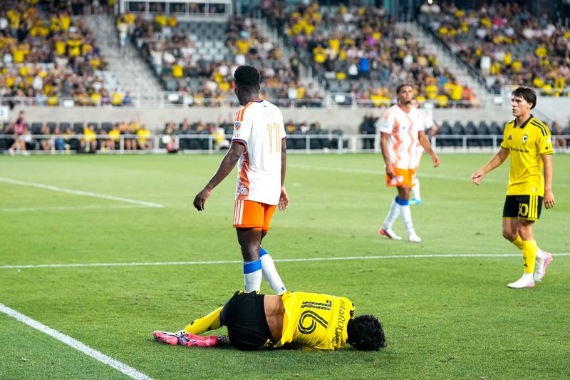 Crew midfielder Taha Habroune stays on the ground after a hit by Cincinnati's Gerardo Valenzuela on on July 25.
