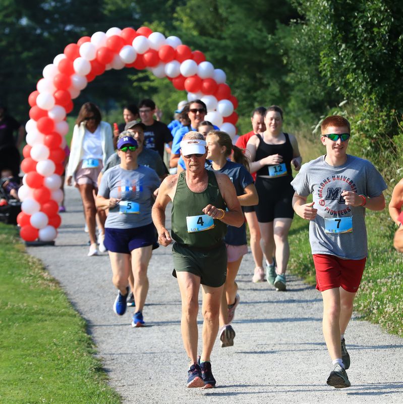 Runners and walkers get started Saturday, July 25, 2026, in the 2026 Greater Alliance Carnation Festival's Trail Run along Iron Horse Trail. The race started and finished First Christian Church in Alliance.