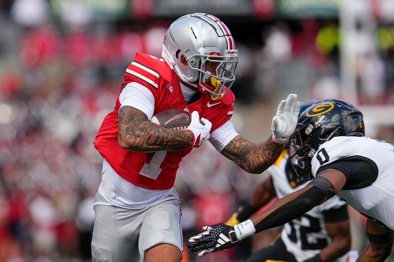 Ohio State Buckeyes wide receiver Brandon Inniss (1) runs past Grambling State Tigers defensive back Quintin Talley (0) during the NCAA football game at Ohio Stadium on Sept. 6, 2025.