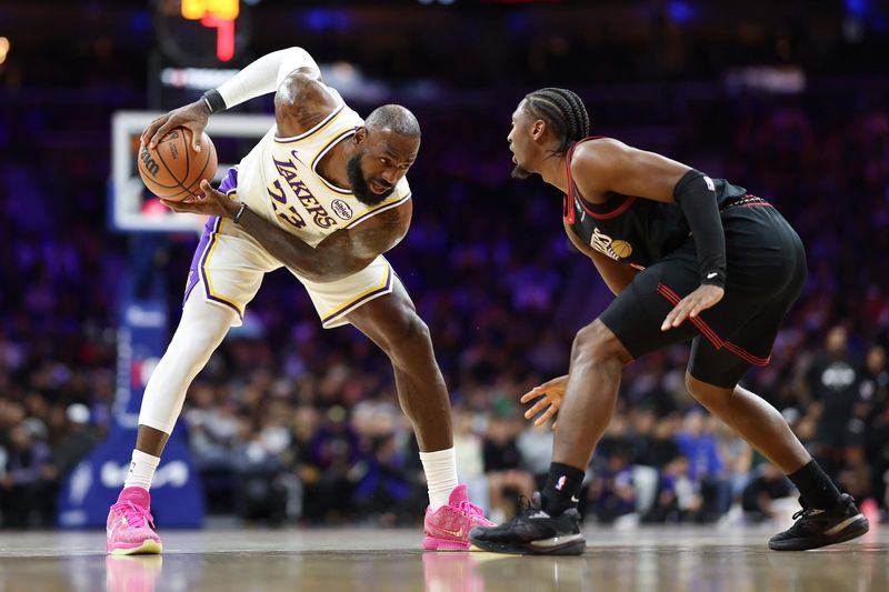 Los Angeles Lakers forward Lebron James (23) controls the ball against Philadelphia 76ers guard Tyrese Maxey on Dec 7, 2025, in Philadelphia, Pennsylvania.