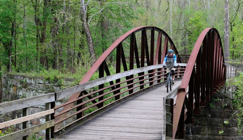 A biker pedals over a bridge along the Lock 29 Trailhead on Saturday, May 14, 2016, in Peninsula, Ohio.  (Phil Masturzo/Akron Beacon Journal)