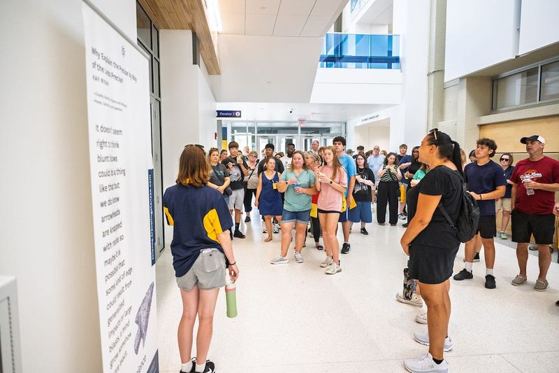 An incoming Kent State University student smiles with her parents during a visit to the Kent Campus.