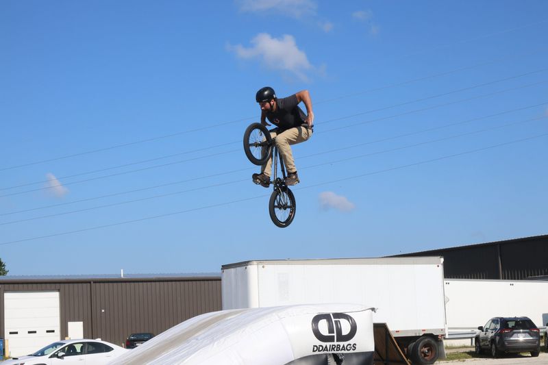 Right Direction BMX rider Nathan Powell flips and flies during a demonstration for the Cutting Edge Manufacturing grand opening on July 29. CEM built the group’s custom ramp.