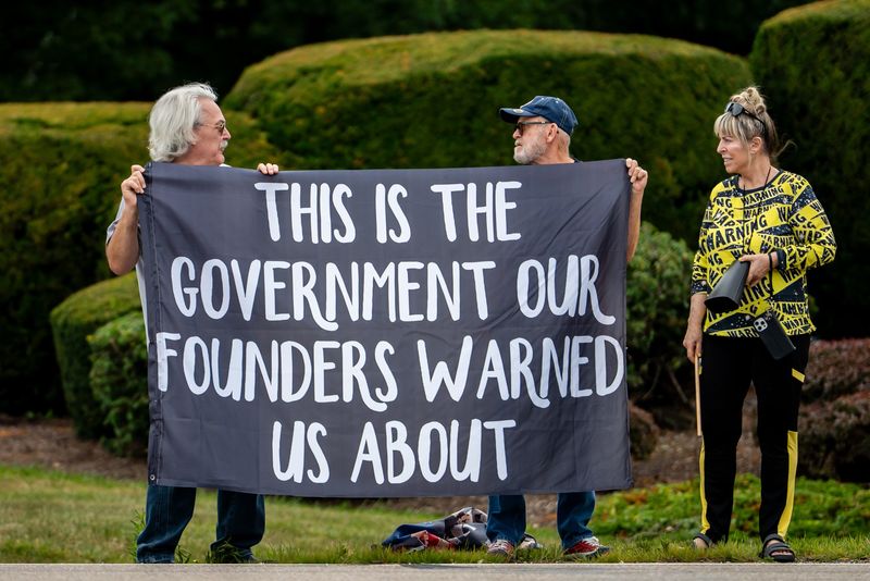 Protesters outside of the Akron-Canton Airport on Aug. 1 call attention to actions by the U.S. Immigration and Customs Enforcement.
