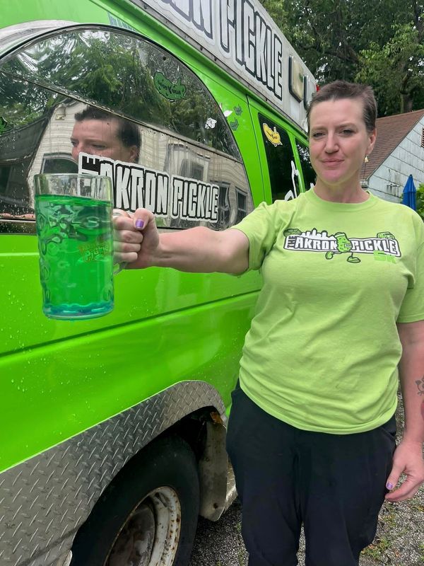 Alicia Kennedy of Akron Pickle holds a stein full of pickle brine for the brine stein holding contest that will take place at the fifth annual Akron Pickle Fest Aug. 9.