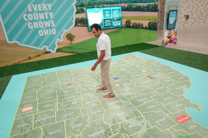 Republican gubernatorial candidate Vivek Ramaswamy records video with his social media team on a giant Ohio map inside the Ohio Agriculture Center during a trip to the Ohio State Fair in Columbus on Aug. 5, 2026.