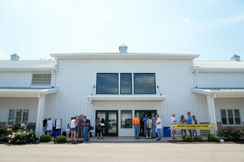 Community members opposed to the US 23 to I-71 connector route stand outside the Delaware County Fairgrounds building on Aug. 6, 2026 in Delaware, Ohio.