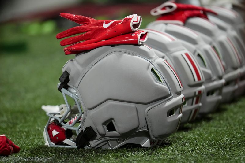 Football helmets with protective padding are lined up during Ohio State training camp inside the Woody Hayes Athletic Center in Columbus on Aug. 7, 2026.