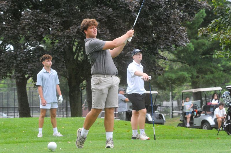 Madison's Josh Maglott watches his tee shot on No. 15 with Hillsdale's Lowen Ferguson and Mapleton's Grayden Kerr in the background at Brookside Golf Course in the Hillsdale Invitational on August 7, 2026.