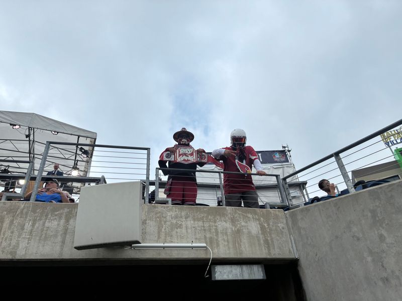 Friends Jose Castilo, left, and Jose Trejo, both from Phoenix, pose for a photo inside Tom Benson Hall of Fame Stadium at the Pro Football Hall of Fame Enshrinement, Aug. 8, 2026, in Canton.