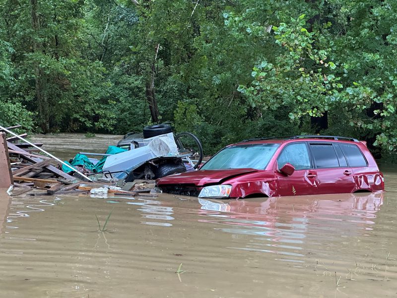 A vehicle is submerged in water in the Jonathan Creek area of South Zanesville on Aug. 11, 2026, after storms brought heavy rainfall to Muskingum and Perry counties.