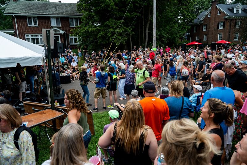 People dance during the annual PorchRokr Music and Art Festival, Aug. 15, 2026, in the Highland Square neighborhood of Akron, Ohio.